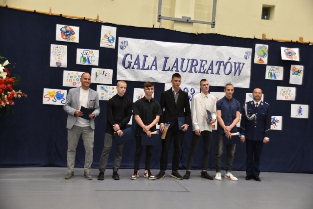 Nagrodzeni uczestnicy Gali Laureatów wraz z otrzymanymi prezentami pozuja do zdjęcia.
